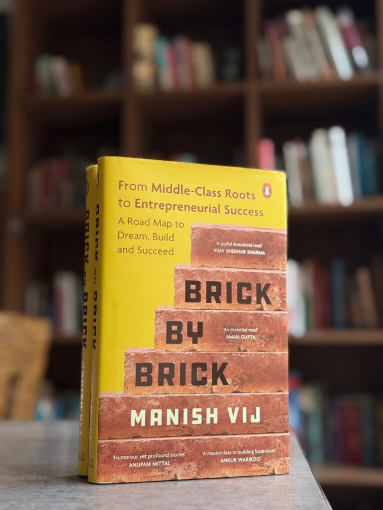 Cover of Brick by Brick by Manish Vij, a book on entrepreneurial success, displayed on the official site banner.